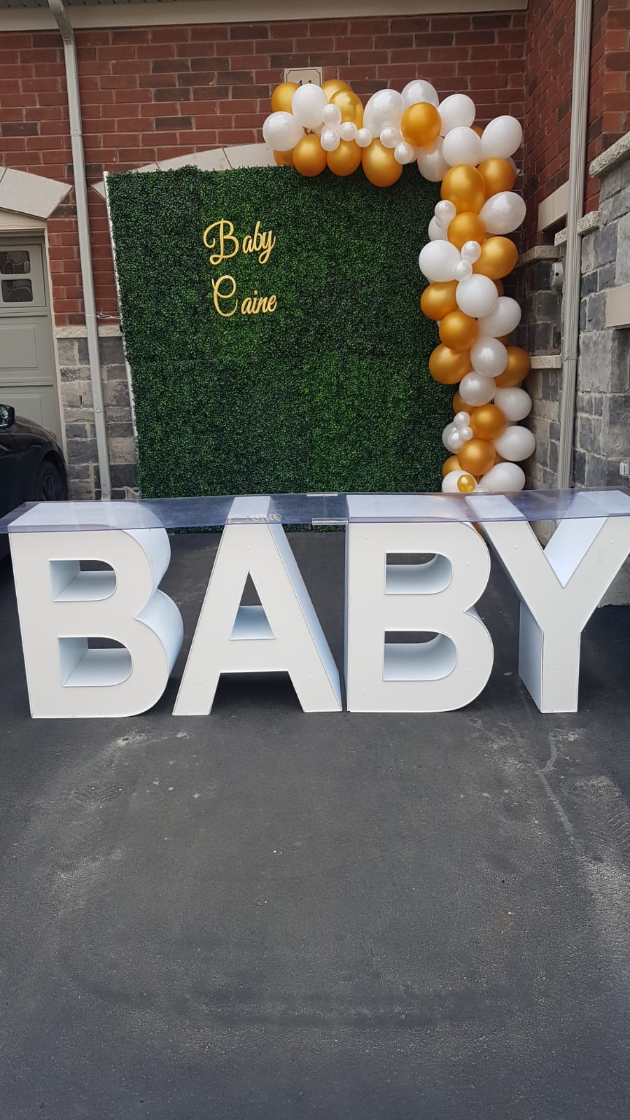 marquee letters with a flower wall and balloon garland