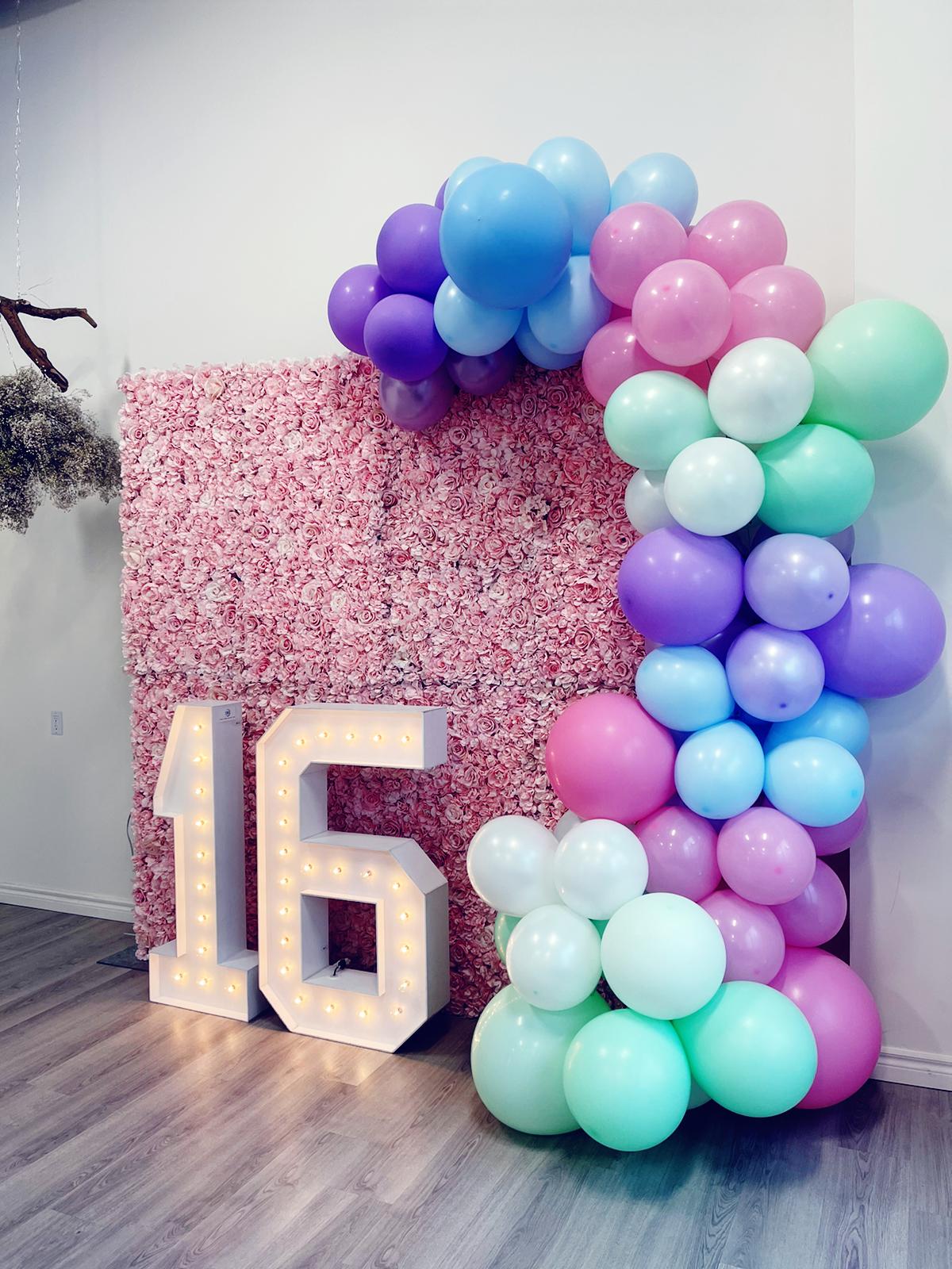 flower wall, balloon decor and marquee numbers for celebrations